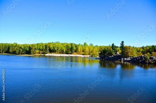 wonderful view of lake and woods under blue sky