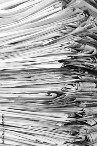 Close-up of old newspapers piled high