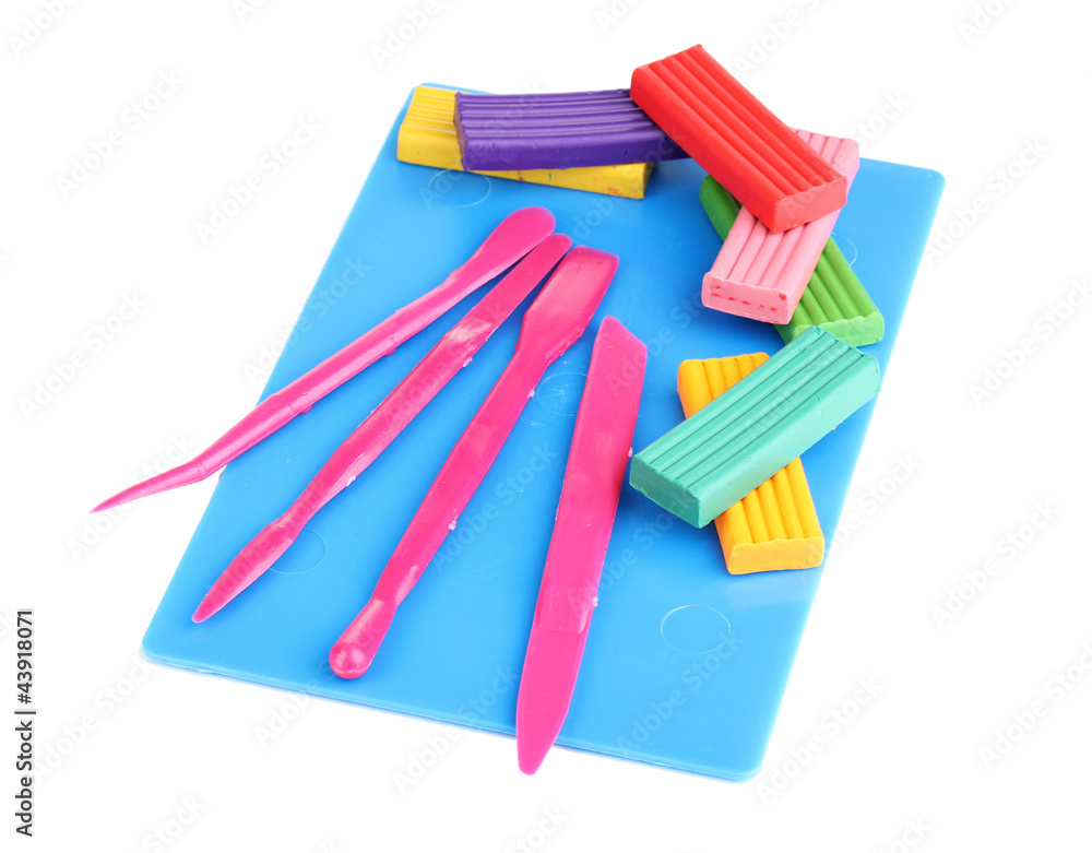 Children bright plasticine on desk with stacks isolated on Children bright plasticine on desk with stacks isolated on