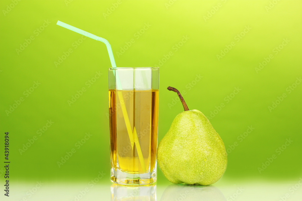 Pear juice in a glass on green background Pear juice in a glass on green background