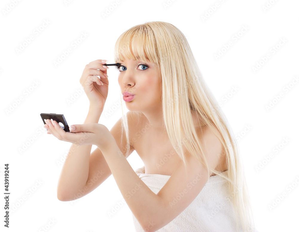 Blonde woman making make-up around the eyes over white Blonde woman making make-up around the eyes over white