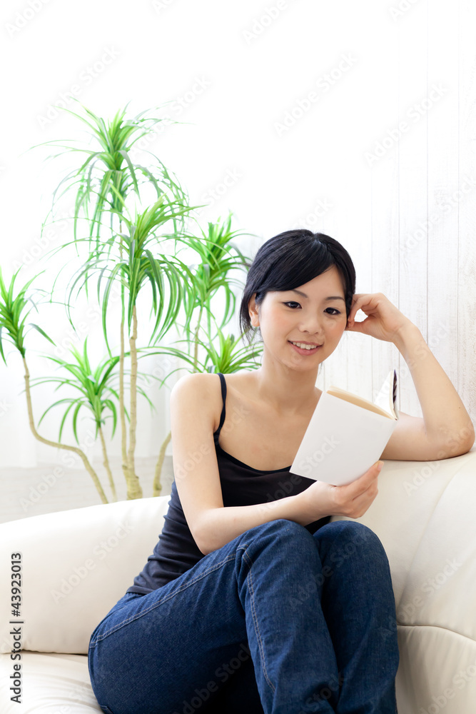 a young asian woman reading a book a young asian woman reading a book