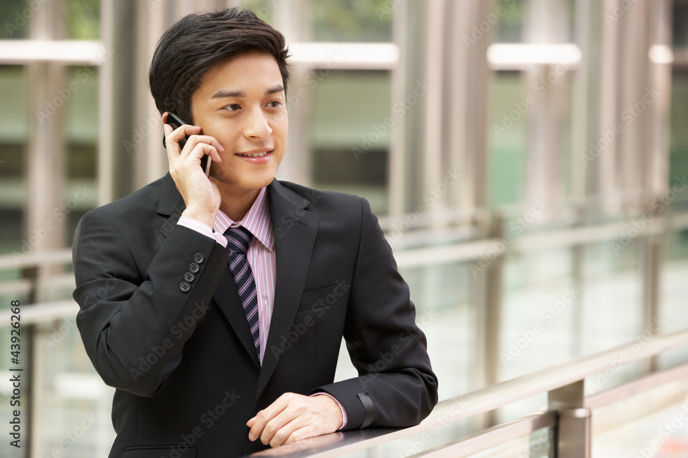 Chinese Businessman Outside Office On Mobile Phone Chinese Businessman Outside Office On Mobile Phone
