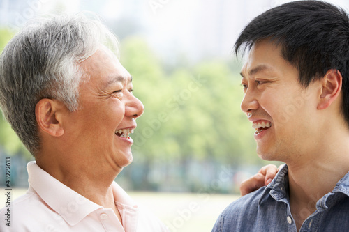 Portrait Of Chinese Father With Adult Son In Park