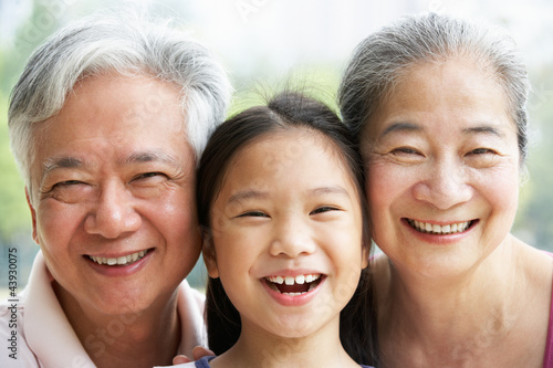 Chinese Grandparents With Granddaughter