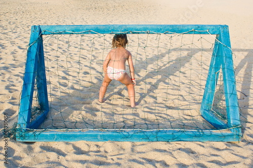 Girl plays beach soccer