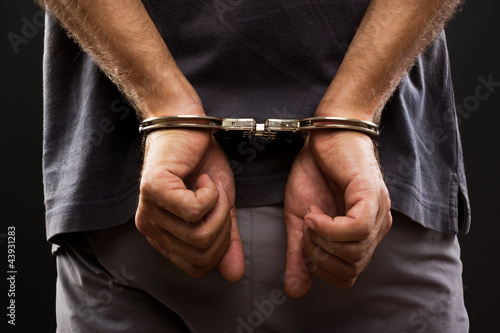 Photographie Close-up. Arrested man handcuffed