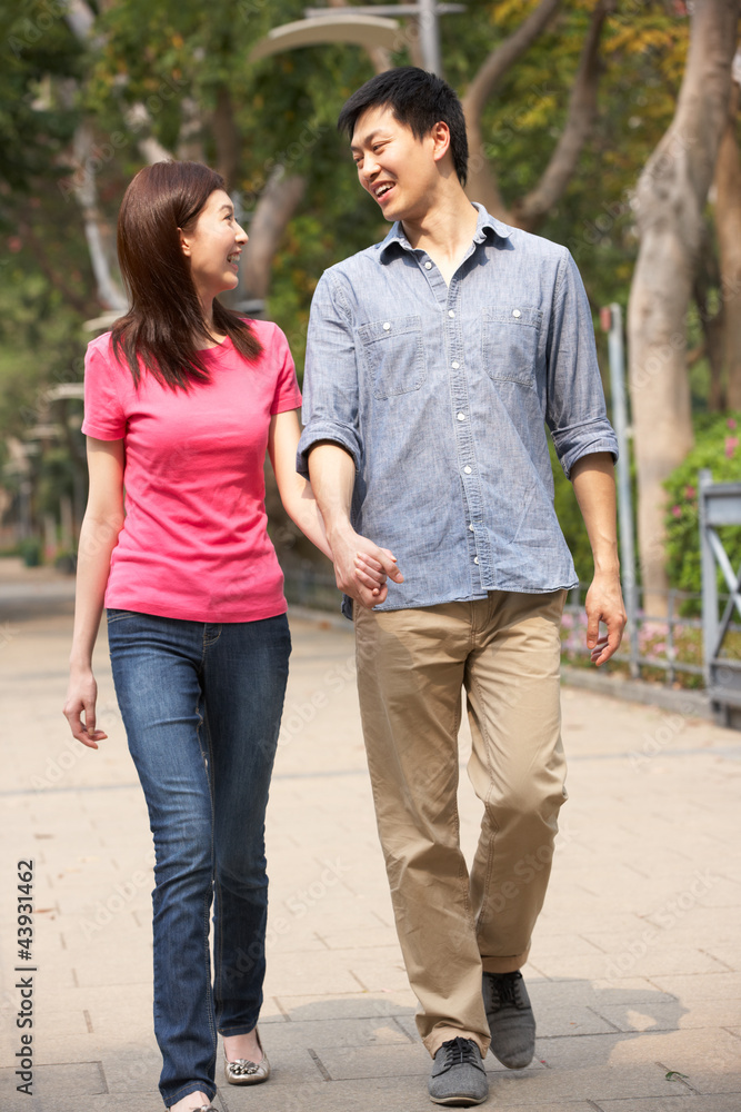 Fototapeta premium Young Chinese Couple Walking In Park