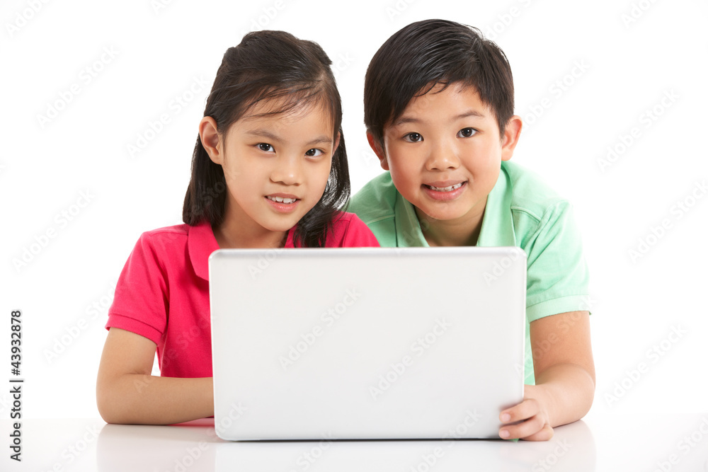 Studio Shot Of Two Chinese Children With Laptop Studio Shot Of Two Chinese Children With Laptop