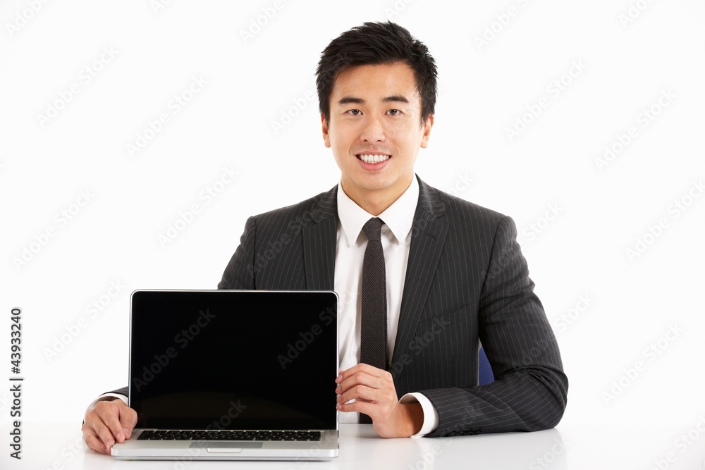 Studio Shot Of Chinese Businessman Working On Laptop Studio Shot Of Chinese Businessman Working On Laptop