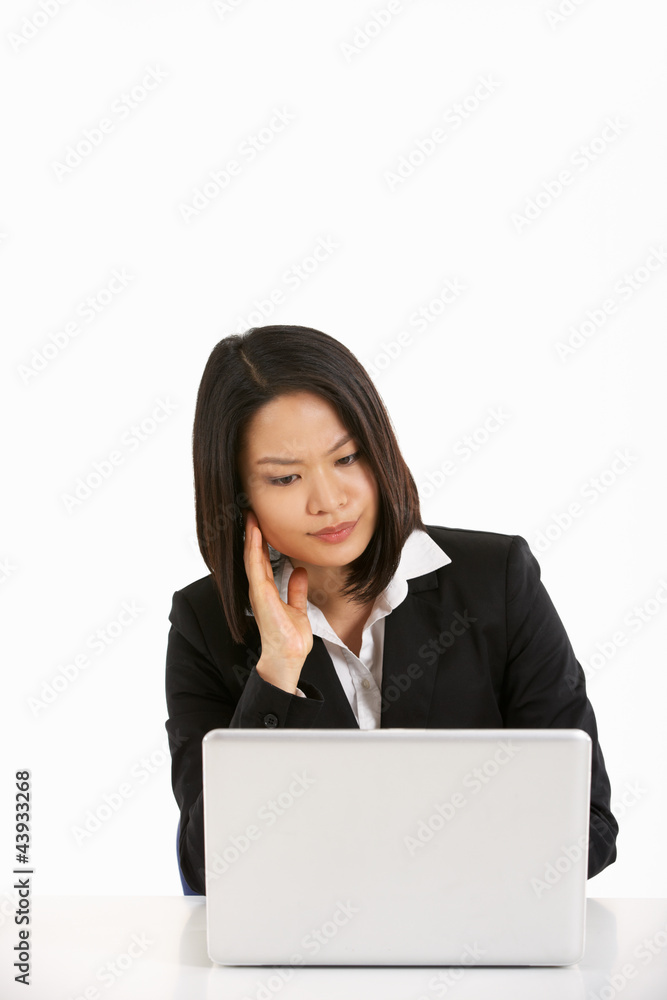 Thoughtful Chinese Businesswoman Working On Laptop Thoughtful Chinese Businesswoman Working On Laptop