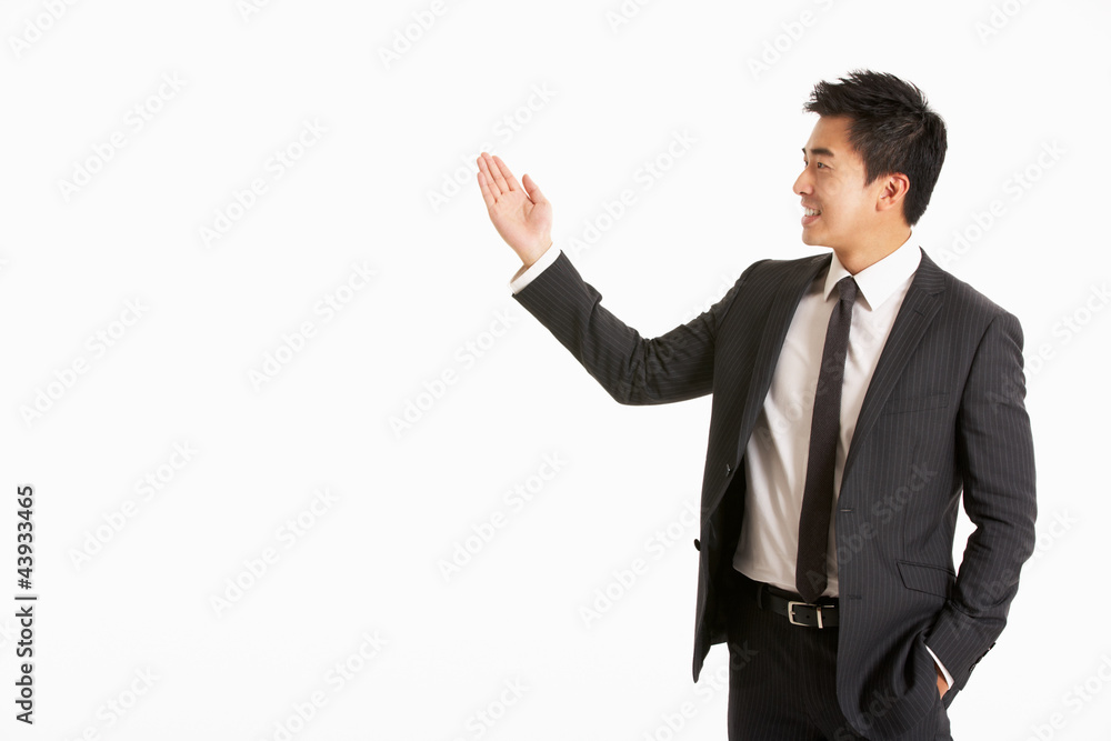 Studio Portrait Of Chinese Businessman Gesturing Studio Portrait Of Chinese Businessman Gesturing