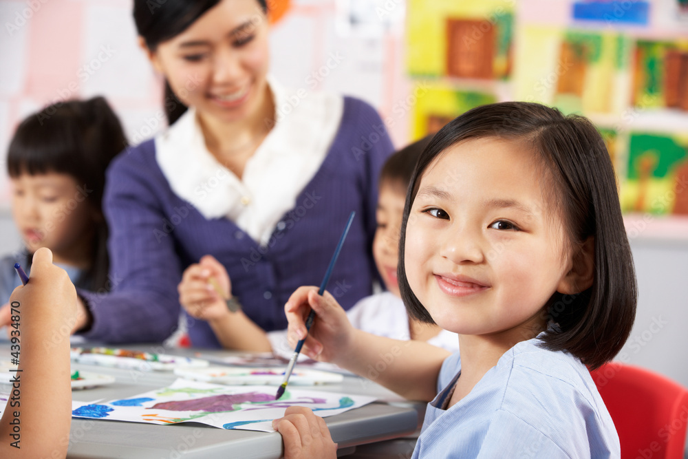 Female Pupil Enjoying Art Class In Chinese School Classroom Female Pupil Enjoying Art Class In Chinese School Classroom