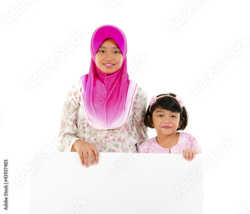 malay sisters with board photo