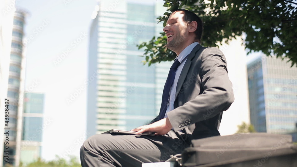 Businessman with laptop having a break and relaxing in the city Businessman with laptop having a break and relaxing in the city