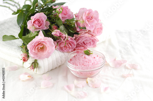 Spa setting with branch roses on towel salt in bowl