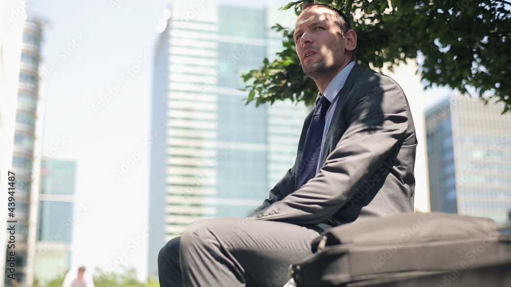 Businessman relaxing and smoking cigarette in the city Businessman relaxing and smoking cigarette in the city