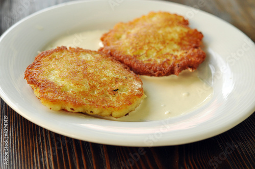 Fried potato pancakes with sour cream