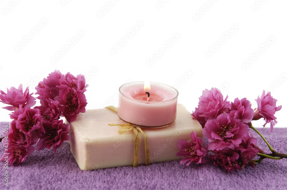 Spa / bath towel and candle on soap with spring flower Spa / bath towel and candle on soap with spring flower