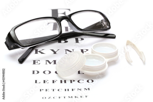 glasses  contact lenses in containers and tweezers 