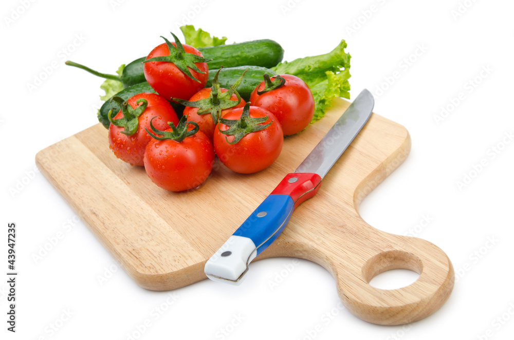 Tomatoes and cucumbers on white Tomatoes and cucumbers on white