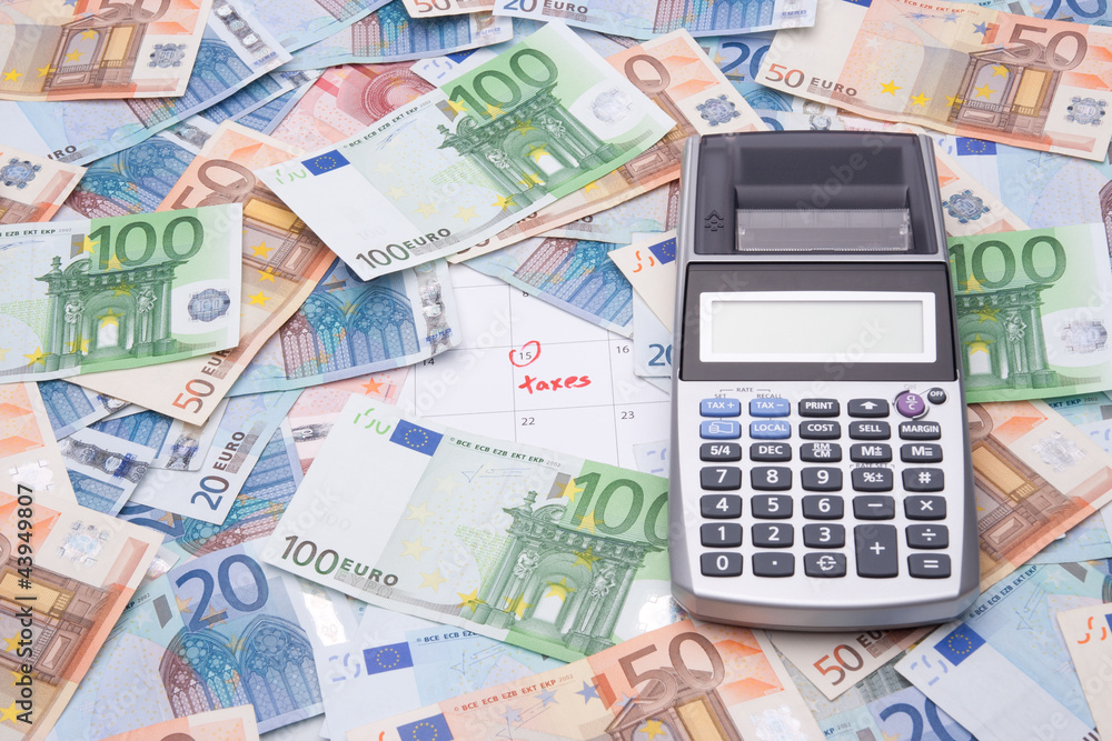 Taxes concept - money and calculator