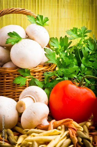 Wicker basket full of fresh champignon mushrooms