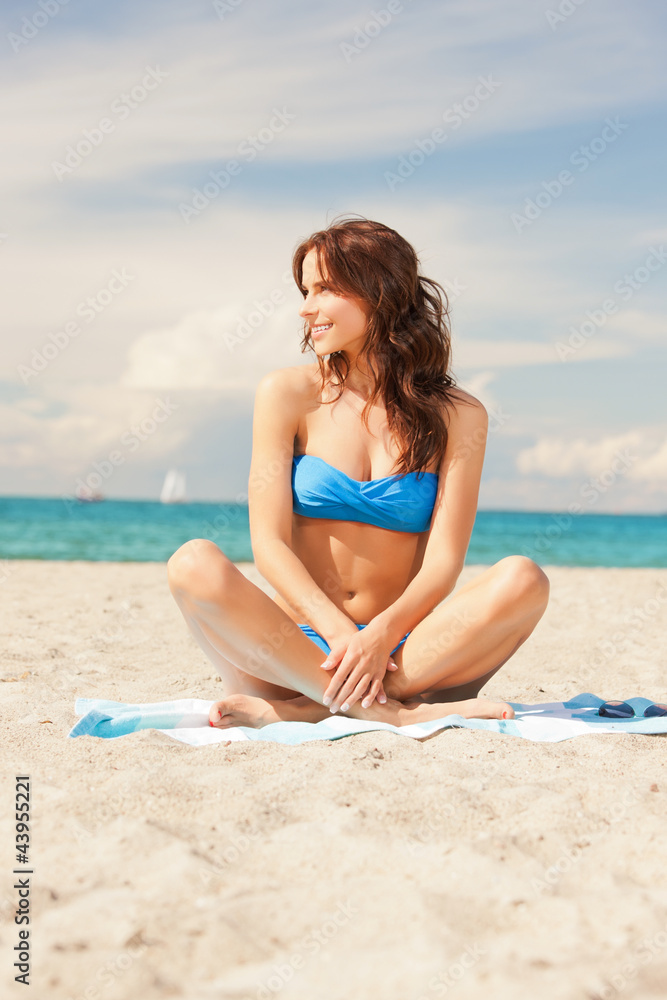 happy smiling woman sitting on a towel happy smiling woman sitting on a towel