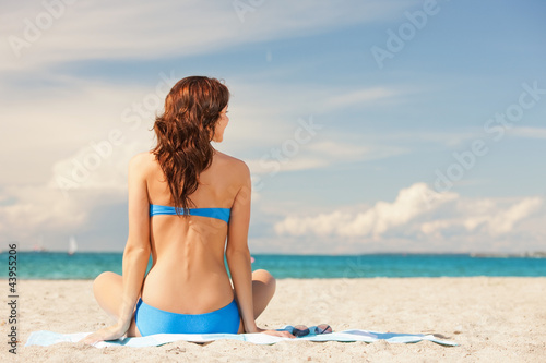 woman practicing yoga lotus pose on the beach © Syda Productions