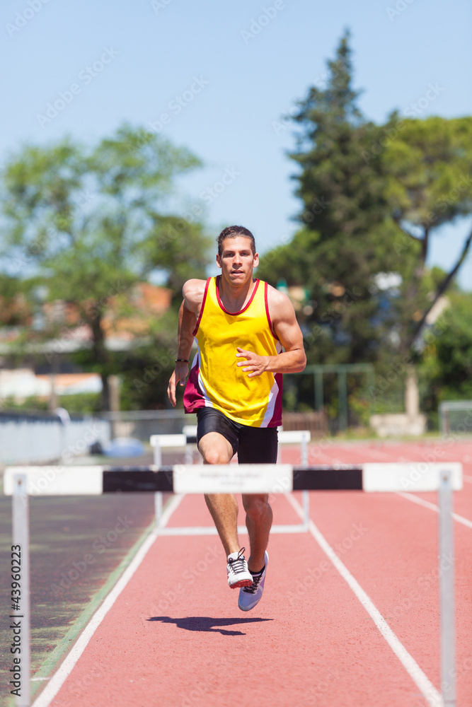 Male Track and Field Athlete during Obstacle Race Male Track and Field Athlete during Obstacle Race