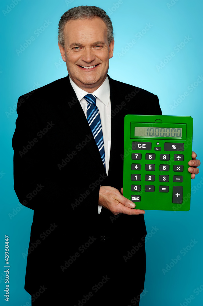 Senior manager showing big green calculator Senior manager showing big green calculator
