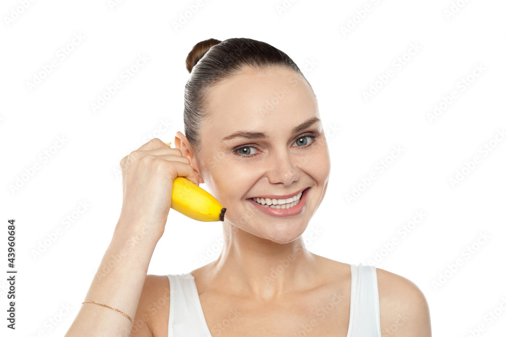 Girl doing call gesture using banana as cellphone Girl doing call gesture using banana as cellphone