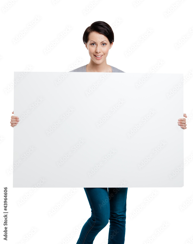 Girl carries a huge sheet of white cardboard , isolated on white Girl carries a huge sheet of white cardboard , isolated on white