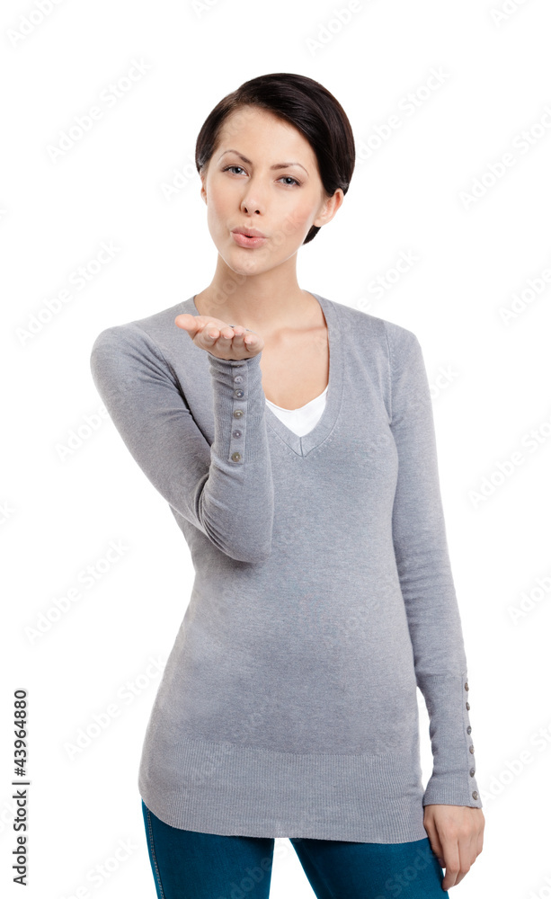 Fototapeta premium Beautiful woman throws a kiss, isolated on white