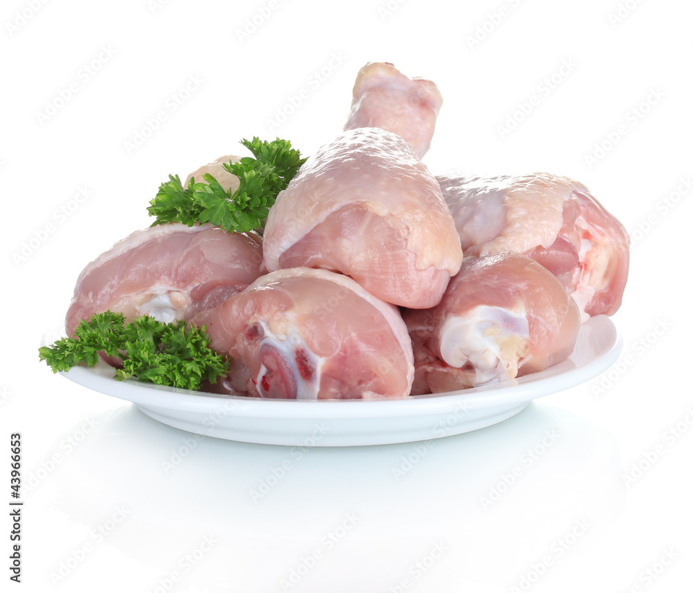 Raw Chicken Drumsticks in plate with parsley isolated on white Raw Chicken Drumsticks in plate with parsley isolated on white