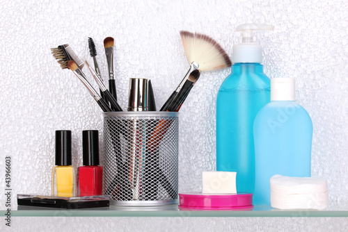 Shelf with cosmetics and toiletries in bathroom