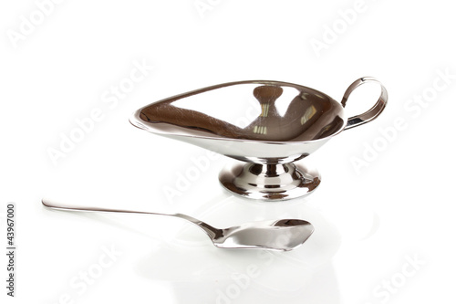 Silver gravy boat and spoon isolated on white