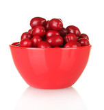 fresh cornel berries in red bowl isolated on white