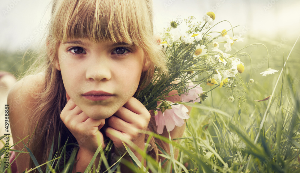 The little girl is lying in the meadow The little girl is lying in the meadow