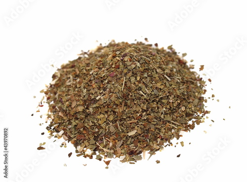macro pile of dried basil spice isolated on white