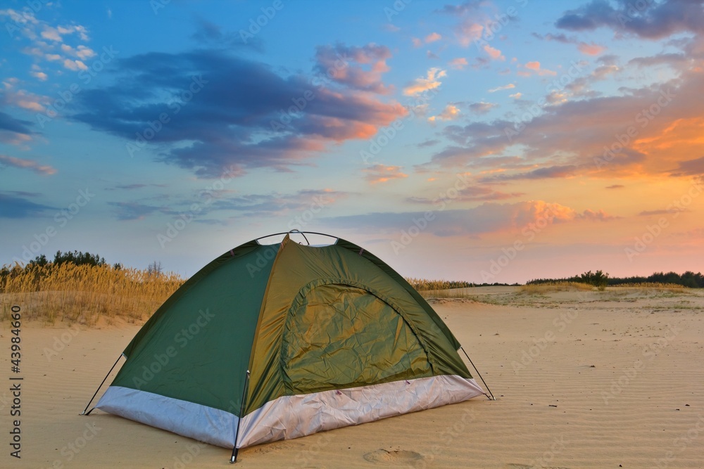 touristic tent on a sand at the evening
