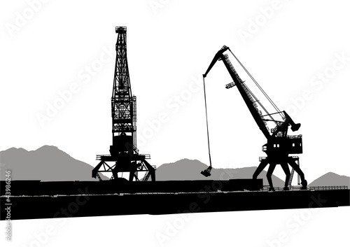 Silhouettes of two port cranes