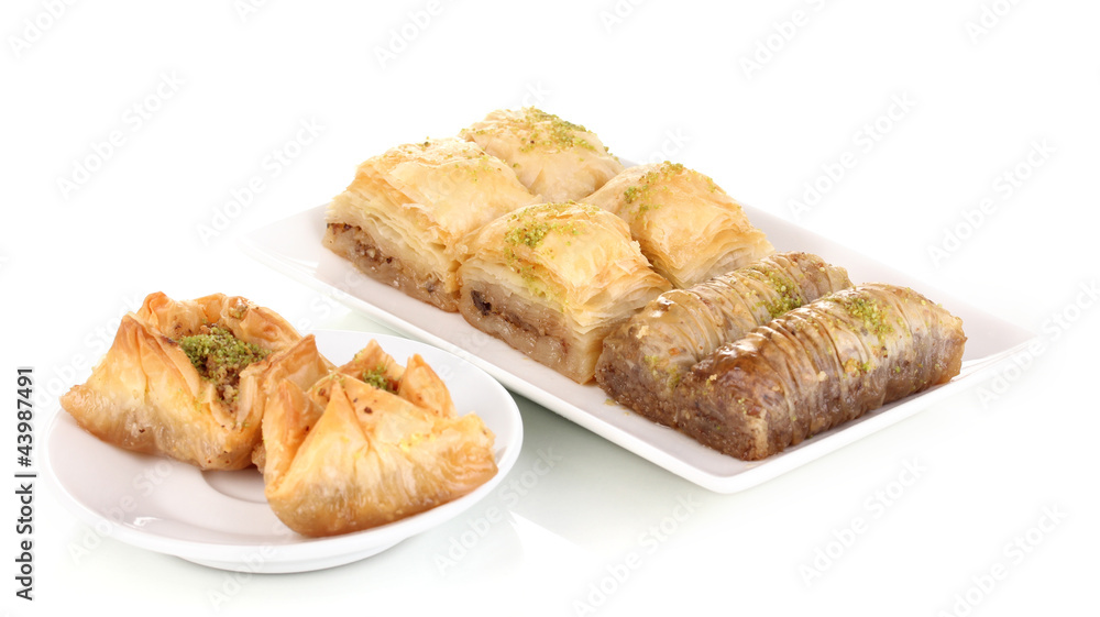 Sweet baklava on plates isolated on white Sweet baklava on plates isolated on white