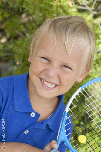 small boy with tennis raket