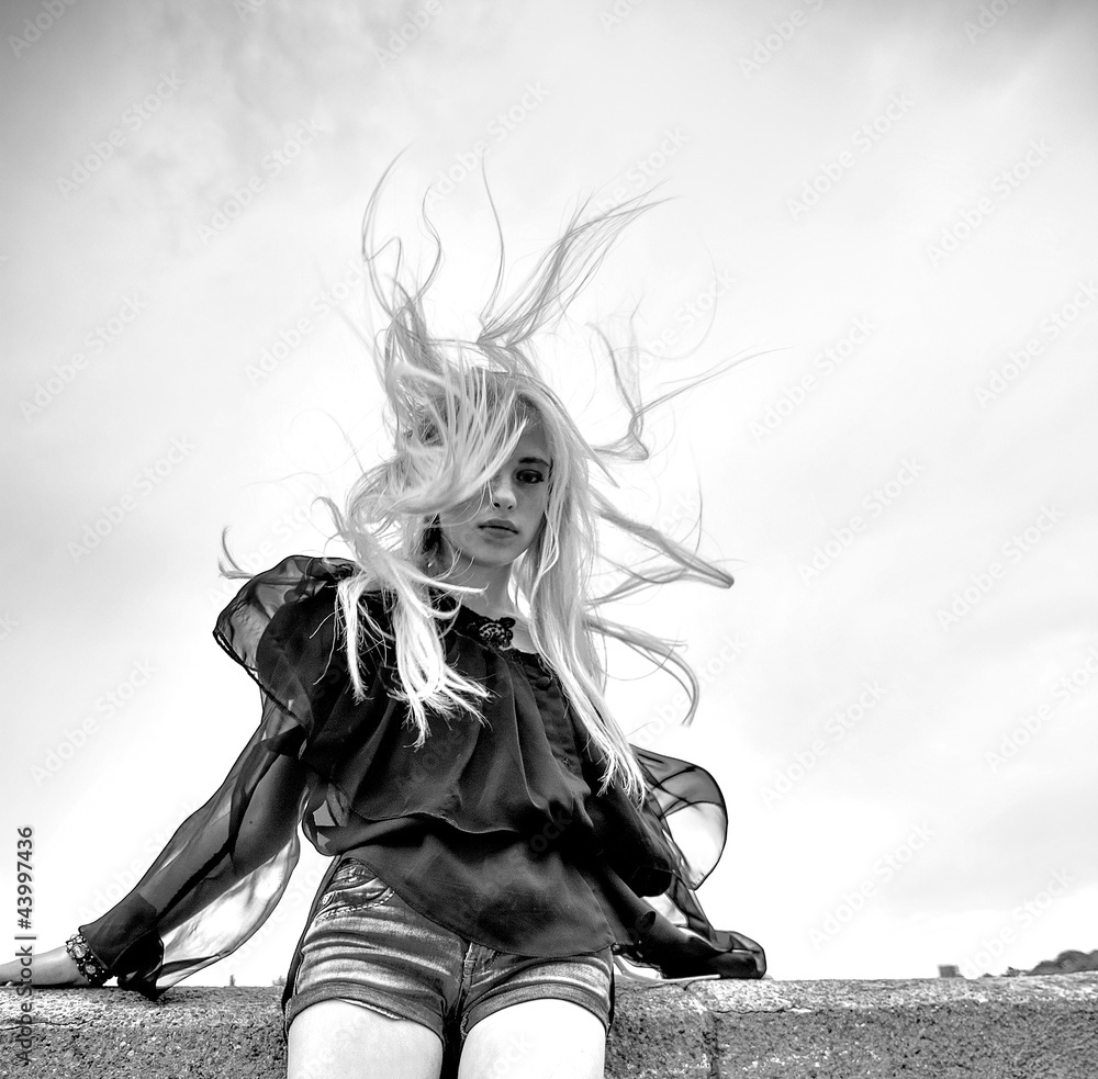 Fototapeta premium Beautiful blond women wind near water