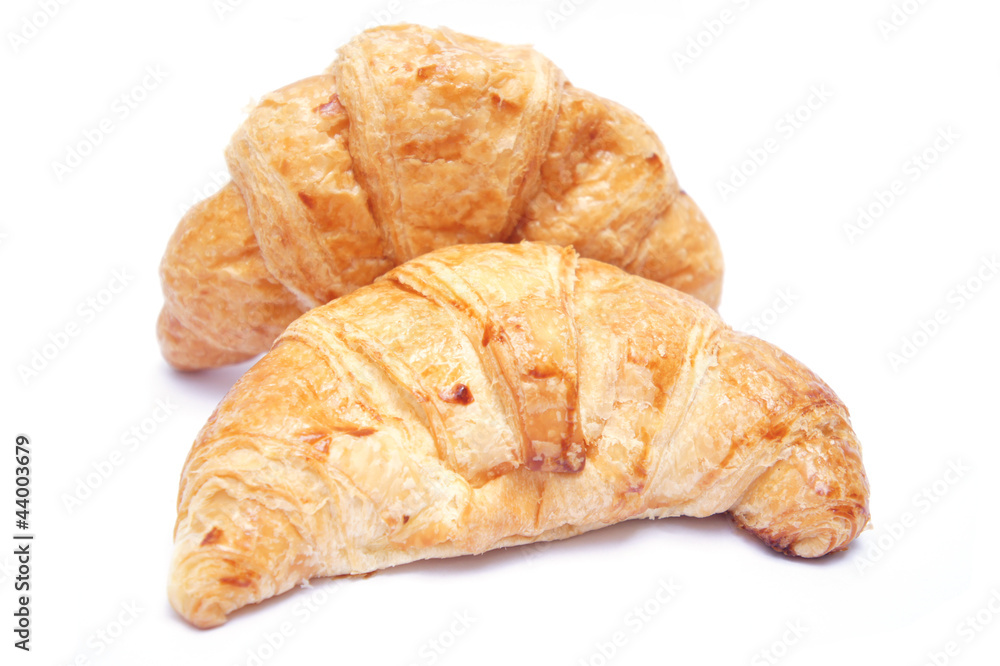 Two croissants on white background
