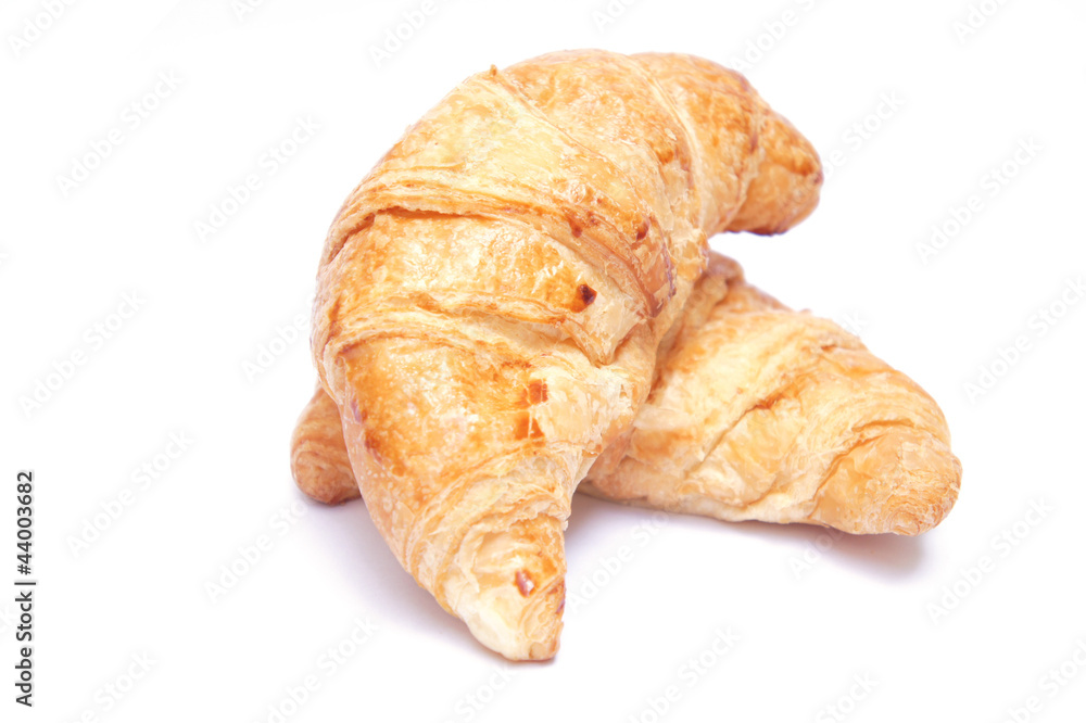 Two croissants on white background