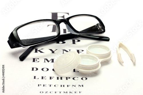 glasses, contact lenses in containers and tweezers,