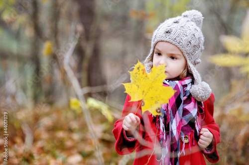 Adorable girl holding a leaf