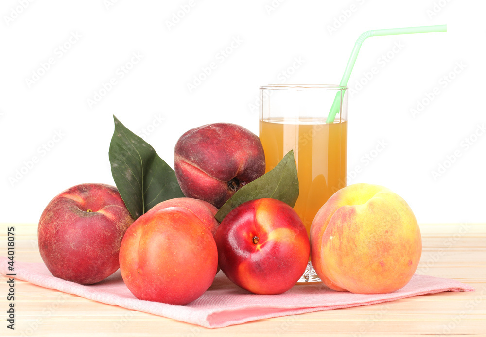 Ripe peaches and juice on wooden table on white background Ripe peaches and juice on wooden table on white background